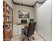 Office space featuring a built-in desk, bookcase, rolling chair and ample cabinet storage at 17805 W Arizona Dr, Surprise, AZ 85374