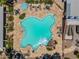 Aerial view of the community pool with ample seating, lush landscaping, and a decorative rock feature at 17805 W Arizona Dr, Surprise, AZ 85374