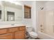 Bright bathroom features a shower-tub combination with neutral tile and a wood-toned vanity at 17862 N 114Th Ln, Surprise, AZ 85378