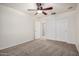 This empty bedroom, features neutral colored walls and carpeting, and a double door closet at 17862 N 114Th Ln, Surprise, AZ 85378