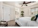 Calm and inviting bedroom featuring plush carpet, natural light from the window, and a ceiling fan at 17862 N 114Th Ln, Surprise, AZ 85378