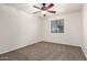 An empty bedroom, with neutral walls and carpeting, along with a ceiling fan and window at 17862 N 114Th Ln, Surprise, AZ 85378