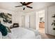 This bedroom offers access to an ensuite bathroom, and features a ceiling fan and neutral walls at 17862 N 114Th Ln, Surprise, AZ 85378