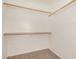 This walk-in closet features built in storage and plush neutral colored carpeting at 17862 N 114Th Ln, Surprise, AZ 85378