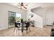 Cozy dining area with modern furniture, tile flooring, a sliding glass door, and a ceiling fan at 17862 N 114Th Ln, Surprise, AZ 85378