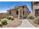 Charming home featuring a covered front porch, desert landscaping, and a well-maintained walkway leading to the entrance at 17862 N 114Th Ln, Surprise, AZ 85378