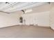 Spacious garage with epoxy flooring, overhead lighting, and ample room for parking and storage at 17862 N 114Th Ln, Surprise, AZ 85378