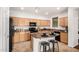 Bright kitchen featuring stainless steel appliances, an island with seating, and ample cabinet space at 17862 N 114Th Ln, Surprise, AZ 85378