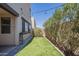 A well-maintained backyard features artificial grass, a cozy patio, and a lush privacy hedge at 1886 E Don Carlos Ave # 136, Tempe, AZ 85281