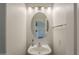 Stylish powder room featuring a sink and oval mirror with overhead lighting at 1886 E Don Carlos Ave # 136, Tempe, AZ 85281