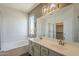 Bright bathroom featuring a large double sink vanity and a soaking tub at 1886 E Don Carlos Ave # 136, Tempe, AZ 85281