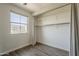 Bright bedroom features a window, closet with curtain, and hard surface flooring for a modern appeal at 1886 E Don Carlos Ave # 136, Tempe, AZ 85281