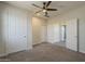 Carpeted bedroom with multiple closets, fan, and recessed lighting at 1886 E Don Carlos Ave # 136, Tempe, AZ 85281