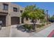 Charming townhome exterior with private garage and well-maintained desert landscaping and a tree at 1886 E Don Carlos Ave # 136, Tempe, AZ 85281