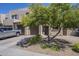 Inviting townhome exterior featuring a private garage,desert landscaping and a large shade tree at 1886 E Don Carlos Ave # 136, Tempe, AZ 85281