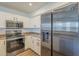 Well-equipped kitchen features stainless steel appliances, white cabinets, and neutral countertops at 1886 E Don Carlos Ave # 136, Tempe, AZ 85281