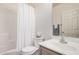 Well-lit bathroom featuring a shower-tub combo, toilet, sink, and wooden cabinets at 205 N 74Th St # 110, Mesa, AZ 85207