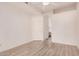 Bedroom showing wood-look floors, ceiling fan, and a doorway to the en-suite bathroom at 205 N 74Th St # 110, Mesa, AZ 85207