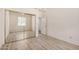 Bright bedroom with neutral tones, wood-look floors, ceiling fan, and mirrored closet at 205 N 74Th St # 110, Mesa, AZ 85207