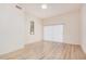 Bright bedroom features wood-look floors, a ceiling fan, and sliding patio doors at 205 N 74Th St # 110, Mesa, AZ 85207