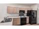 Efficient kitchen featuring black appliances, ample counter space, and wood cabinets at 205 N 74Th St # 110, Mesa, AZ 85207