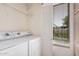 Convenient laundry room includes a washer, dryer, storage shelving and natural light at 205 N 74Th St # 110, Mesa, AZ 85207