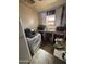 Outdated kitchen featuring older appliances, cabinets, and a window over the sink at 2415 E Wood St, Phoenix, AZ 85040