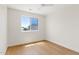 Bright, well-lit room with clean lines, a large window, and hardwood floors at 2421 S 65Th Dr, Phoenix, AZ 85043