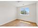 Sunny bedroom with a large window that offers a view of lush greenery at 2421 S 65Th Dr, Phoenix, AZ 85043