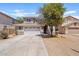 Charming home featuring a well-maintained front yard, a large driveway, and a two-car garage at 2421 S 65Th Dr, Phoenix, AZ 85043