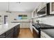 Well-lit kitchen features a white island, plenty of cabinet space, black appliances, and a view from the window at 2421 S 65Th Dr, Phoenix, AZ 85043