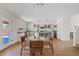 Open kitchen and dining area with bright countertops, wood floors, modern island, and stainless steel appliances at 2421 S 65Th Dr, Phoenix, AZ 85043