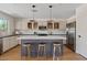 Bright kitchen featuring an island, bar stool seating, stainless steel appliances, and updated cabinetry at 2421 S 65Th Dr, Phoenix, AZ 85043