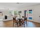 Bright open floorplan with a modern dining table, white couch, and multiple windows for natural light at 2421 S 65Th Dr, Phoenix, AZ 85043