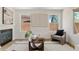 Cozy living room features a fireplace, modern decor, neutral color palette, and ample natural light at 2421 S 65Th Dr, Phoenix, AZ 85043