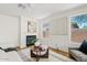 Bright living room with modern fireplace, neutral color scheme, and multiple windows for plenty of natural light at 2421 S 65Th Dr, Phoenix, AZ 85043
