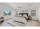 Bright main bedroom with a large window, ceiling fan, a modern rug, and a large bed at 2421 S 65Th Dr, Phoenix, AZ 85043