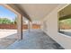 Covered patio featuring stylish stone flooring, perfect for outdoor lounging and entertaining at 2421 S 65Th Dr, Phoenix, AZ 85043