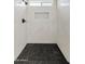 Modern walk-in shower features black marble floor, black fixtures, and decorative niche at 2421 S 65Th Dr, Phoenix, AZ 85043