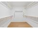 Spacious walk-in closet with hardwood floors and custom shelving throughout at 2421 S 65Th Dr, Phoenix, AZ 85043