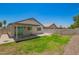 Well-maintained backyard features a covered patio, grassy area, and block wall fencing for added privacy at 3014 W Zachary Dr, Phoenix, AZ 85027