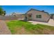 Spacious backyard with lush green grass, a covered patio and secure block wall fencing for privacy at 3014 W Zachary Dr, Phoenix, AZ 85027