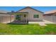 Charming backyard featuring a covered patio and a grassy area, perfect for relaxation and outdoor enjoyment at 3014 W Zachary Dr, Phoenix, AZ 85027