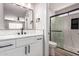 This bathroom features a framed mirror, single sink, white cabinets, and an enclosed shower at 3014 W Zachary Dr, Phoenix, AZ 85027