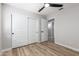 An empty bedroom with wood flooring, a ceiling fan, neutral paint, and a double closet at 3014 W Zachary Dr, Phoenix, AZ 85027