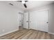 An empty bedroom with wood flooring, a ceiling fan, neutral paint, and a double closet at 3014 W Zachary Dr, Phoenix, AZ 85027
