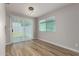 Dining room with hardwood floors, sliding glass door, modern light fixture, and natural light at 3014 W Zachary Dr, Phoenix, AZ 85027