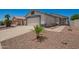 Well-maintained home with a spacious driveway, desert landscaping, and a two-car garage at 3014 W Zachary Dr, Phoenix, AZ 85027