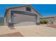 Home with a two-car garage, desert landscaping, and a spacious driveway on a sunny day at 3014 W Zachary Dr, Phoenix, AZ 85027