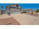 Home featuring a spacious driveway, well-kept desert landscaping, and an attached two-car garage at 3014 W Zachary Dr, Phoenix, AZ 85027